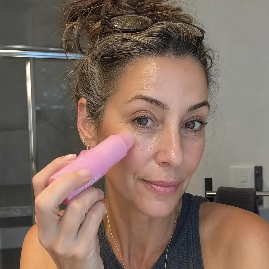 Woman applying the balm under her eye